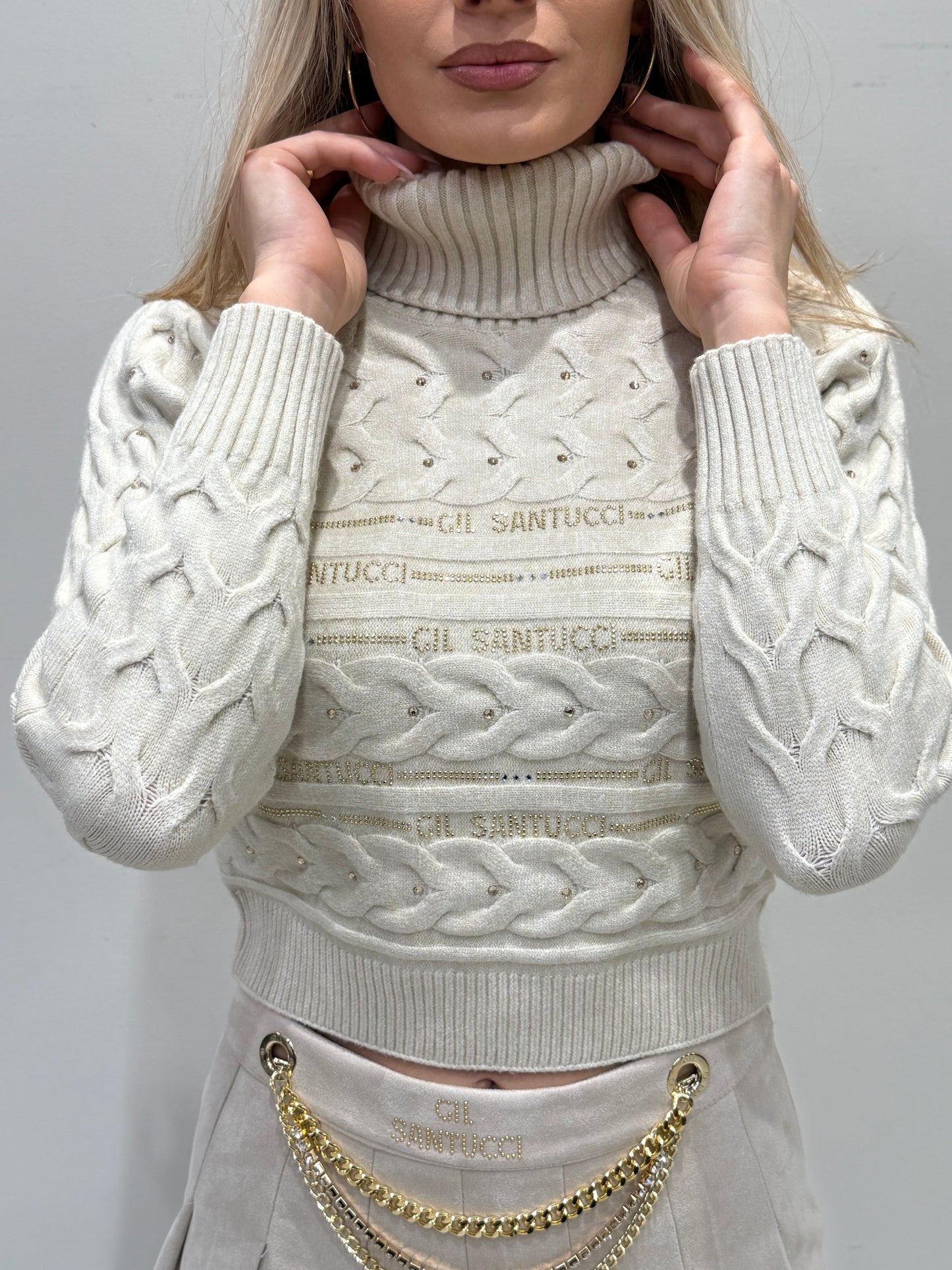 Minigonna a pieghe in camoscio sintetico color panna